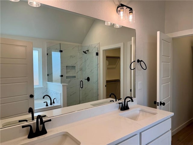 bathroom featuring separate shower and tub, vanity, vaulted ceiling, and hardwood / wood-style flooring