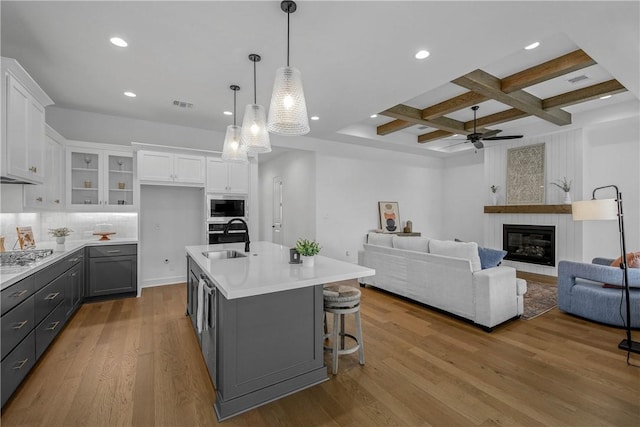 3576 Chantilly Path, Bryan, TX 77808 - kitchen with built in microwave, coffered ceiling, white cabinets, a ceiling fan, and light countertops