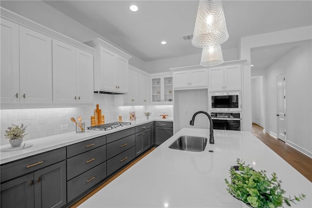 3576 Chantilly Path, Bryan, TX 77808 - kitchen featuring appliances with stainless steel finishes, white cabinetry, light countertops, decorative backsplash, and recessed lighting