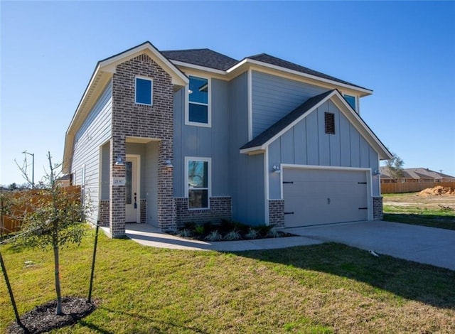 2130 Mountain Wind Loop, Bryan, TX 77807 - view of front of home featuring a garage, a front lawn, brick siding, concrete driveway, and board and batten siding