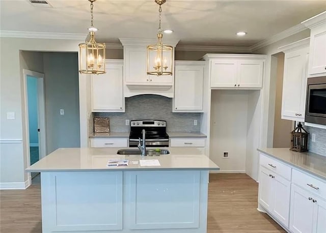 2130 Mountain Wind Loop, Bryan, TX 77807 - kitchen featuring appliances with stainless steel finishes, custom range hood, light wood-type flooring, a chandelier, and ornamental molding