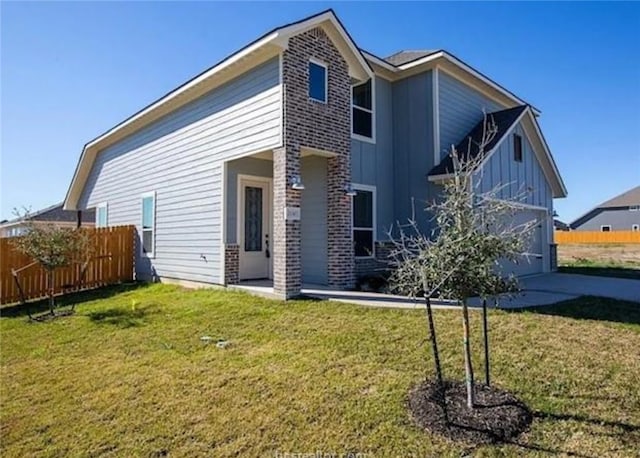 2130 Mountain Wind Loop, Bryan, TX 77807 - rear view of property with board and batten siding, brick siding, and a garage