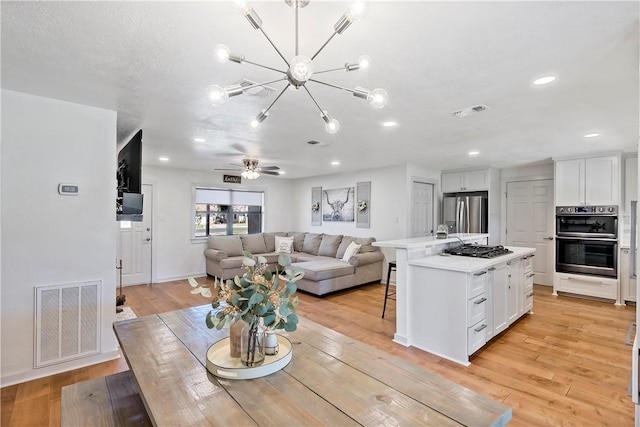 interior space featuring recessed lighting, visible vents, and light wood-style flooring