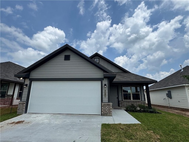 1214 Highgarden Dr, Navasota, TX 77868 - view of front facade with an attached garage, concrete driveway, brick siding, and a front yard