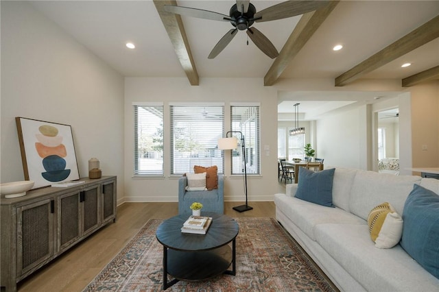 living room with beam ceiling, ceiling fan, and dark wood-type flooring