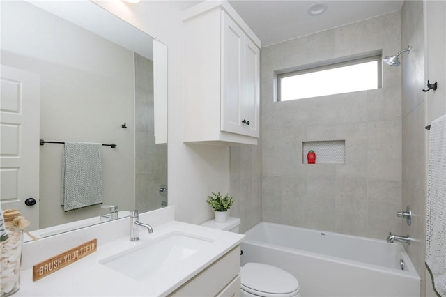 full bathroom featuring vanity, toilet, and tiled shower / bath combo