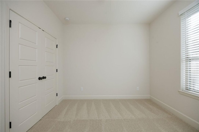 unfurnished room with light carpet