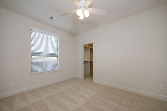 unfurnished room with light carpet and ceiling fan