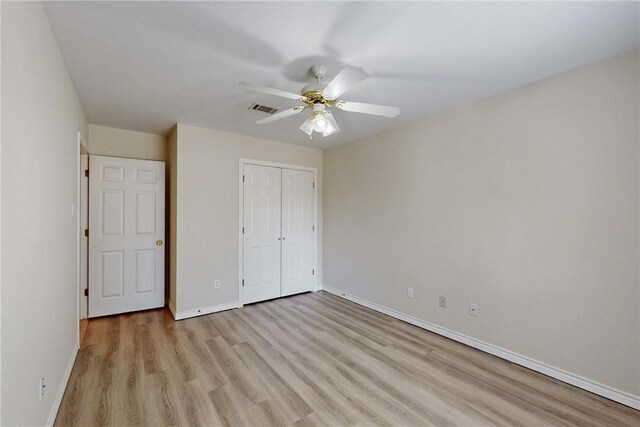 2600 Greenberry Cir, College Station, TX 77845 - unfurnished bedroom with light wood-style flooring, baseboards, a closet, and a ceiling fan