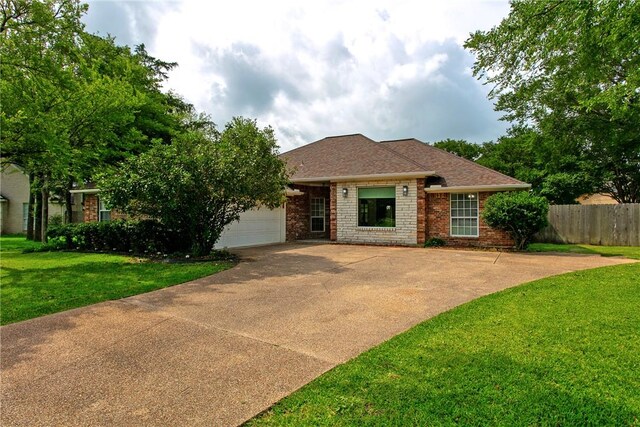 2600 Greenberry Cir, College Station, TX 77845 - view of front facade featuring brick siding, concrete driveway, and a garage