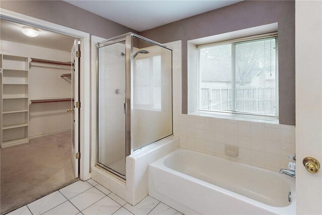 2600 Greenberry Cir, College Station, TX 77845 - full bath featuring a spacious closet, a stall shower, a garden tub, and tile patterned floors