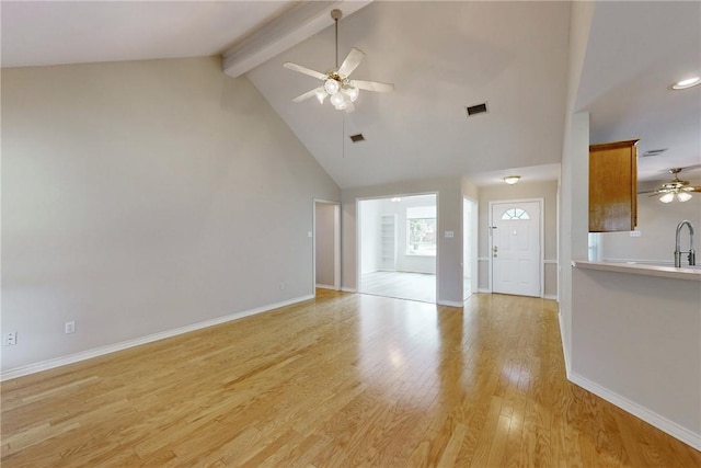 2600 Greenberry Cir, College Station, TX 77845 - unfurnished living room featuring a ceiling fan, beam ceiling, high vaulted ceiling, light wood-style flooring, and baseboards