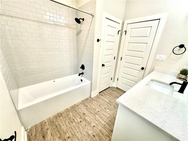 bathroom with vanity and tiled shower / bath combo