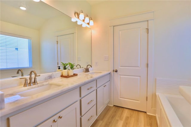 172 Pleasant Path, Somerville, TX 77879 - full bath featuring double vanity, wood finished floors, a garden tub, and vaulted ceiling