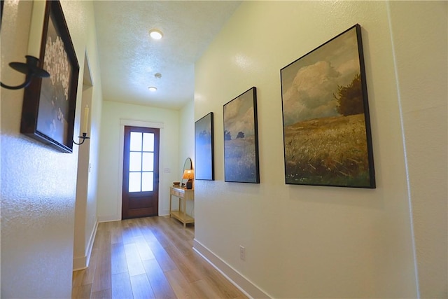 172 Pleasant Path, Somerville, TX 77879 - doorway to outside featuring wood finished floors and baseboards