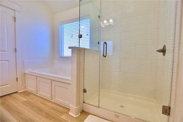 172 Pleasant Path, Somerville, TX 77879 - bathroom featuring a stall shower, wood finished floors, and a bath