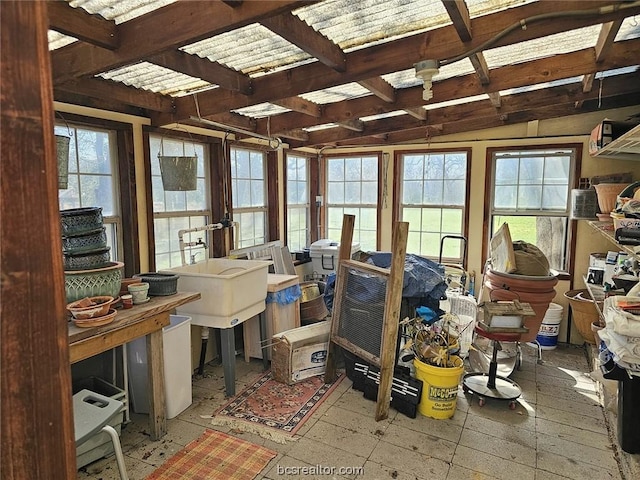 sunroom / solarium featuring french doors, vaulted ceiling, a healthy amount of sunlight, and sink