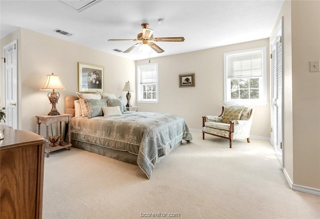 carpeted bedroom featuring multiple windows and ceiling fan