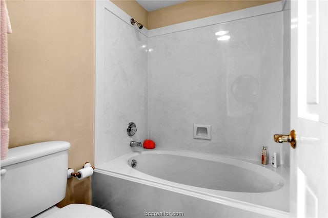 bathroom with bathtub / shower combination and toilet