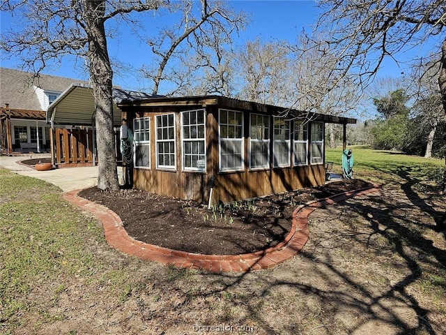 view of side of home with a sunroom