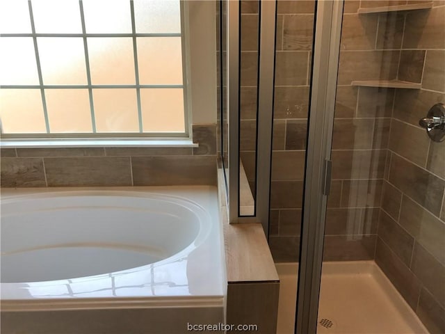 bathroom featuring plus walk in shower