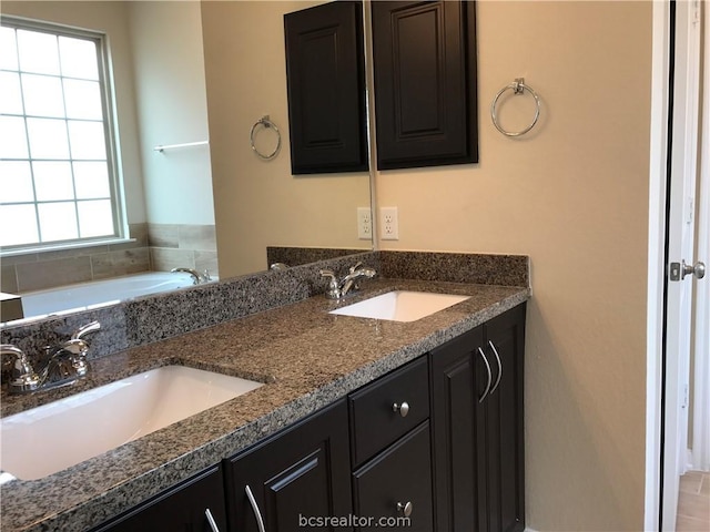 bathroom with vanity and a bathtub