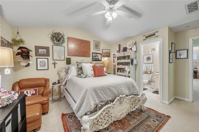 bedroom featuring light carpet, ceiling fan, lofted ceiling, and ensuite bath