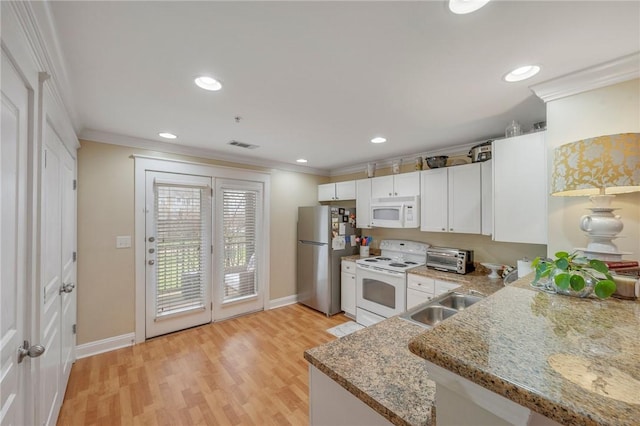 kitchen with kitchen peninsula, sink, crown molding, white appliances, and white cabinets