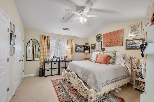 bedroom featuring ceiling fan, light colored carpet, and vaulted ceiling