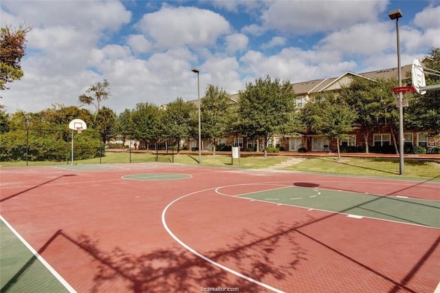 view of basketball court featuring a lawn