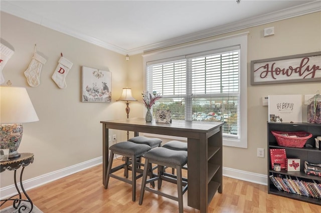 home office featuring crown molding and light hardwood / wood-style flooring