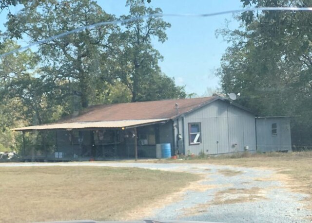 exterior space featuring a carport and a front lawn