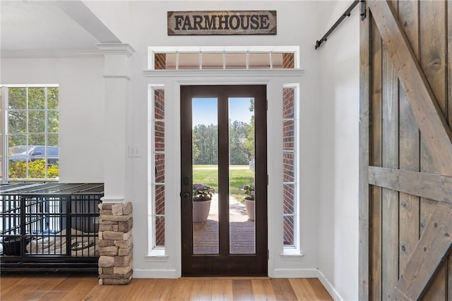 2092 Fm 1486th Rd, Anderson, TX 77830 - entrance foyer with a barn door, wood finished floors, crown molding, and ornate columns