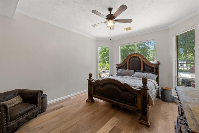 2092 Fm 1486th Rd, Anderson, TX 77830 - bedroom with visible vents, a textured ceiling, light wood-style floors, and crown molding