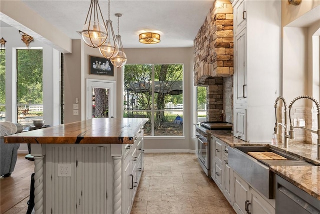 2092 Fm 1486th Rd, Anderson, TX 77830 - kitchen with stainless steel appliances, a kitchen breakfast bar, a sink, baseboards, and light stone counters