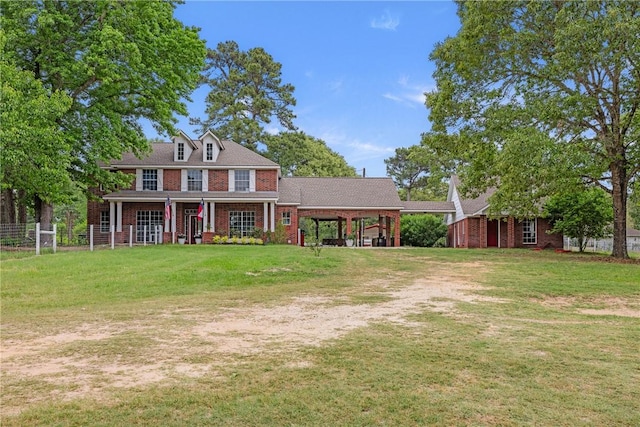 2092 Fm 1486th Rd, Anderson, TX 77830 - colonial house featuring brick siding, a front lawn, driveway, and fence