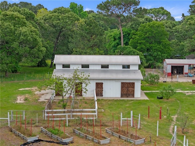2092 Fm 1486th Rd, Anderson, TX 77830 - view of pole building with fence, a lawn, a garden, and a view of trees