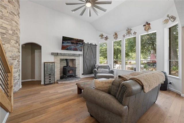 2092 Fm 1486th Rd, Anderson, TX 77830 - living area featuring a wood stove, light wood-type flooring, a wealth of natural light, and ceiling fan