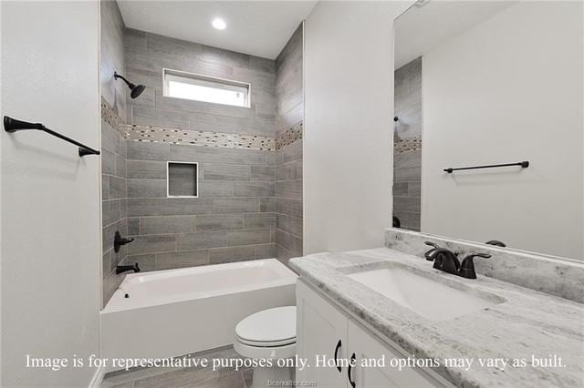 bathroom with toilet,  shower combination, and vanity