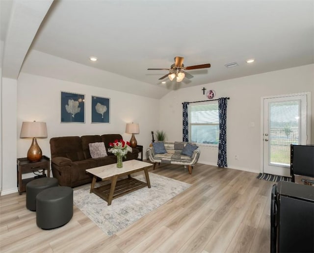 living room featuring light wood-type flooring, baseboards, and recessed lighting