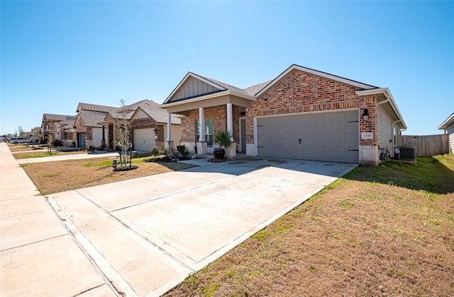 view of front of property with central air condition unit, a garage, brick siding, board and batten siding, and a front yard