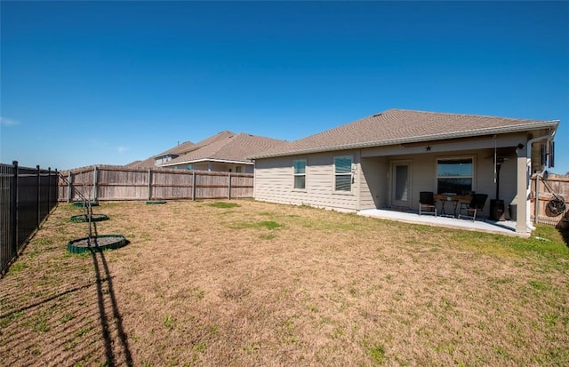 rear view of property with a patio area, a fenced backyard, and a lawn