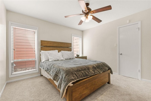 bedroom with ceiling fan, carpet floors, and baseboards