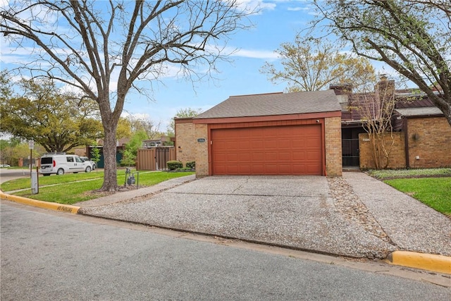 view of front of home with concrete driveway, an attached garage, brick siding, and fence