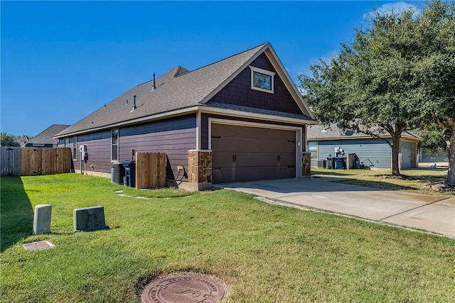 view of home's exterior featuring a yard, a garage, and central air condition unit