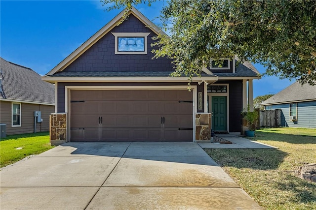 craftsman-style house with cooling unit, a garage, and a front yard