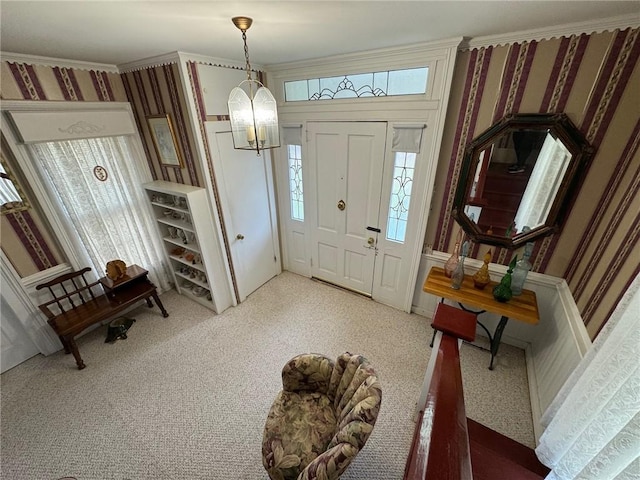 foyer with carpet floors and an inviting chandelier