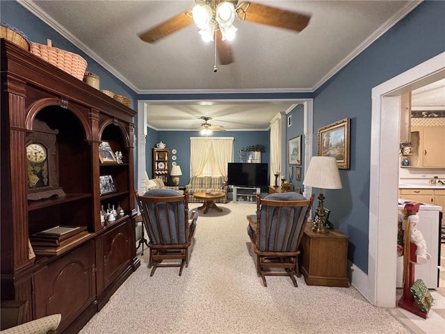 living area with light colored carpet, ceiling fan, and ornamental molding