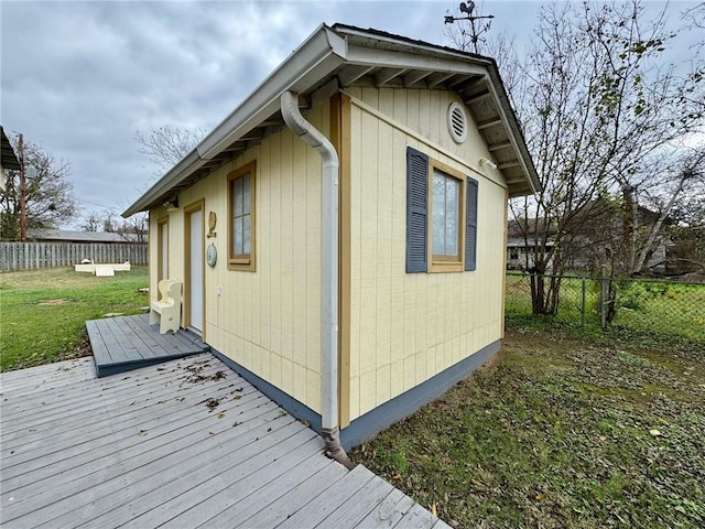 view of property exterior featuring a yard and a wooden deck