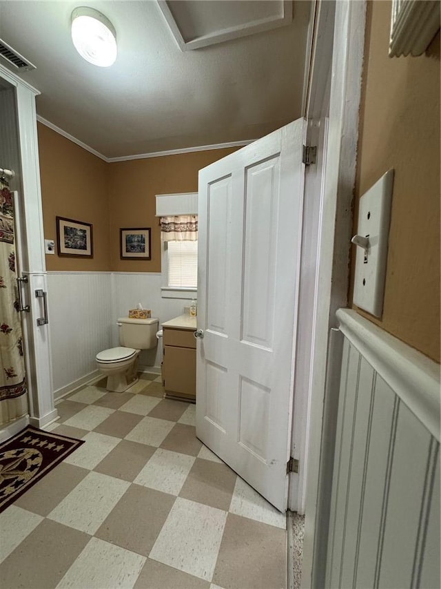 bathroom featuring toilet and crown molding